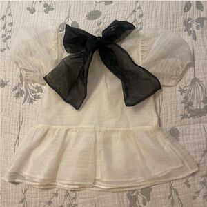 classy white flowy top with a gorgeous bow on the back